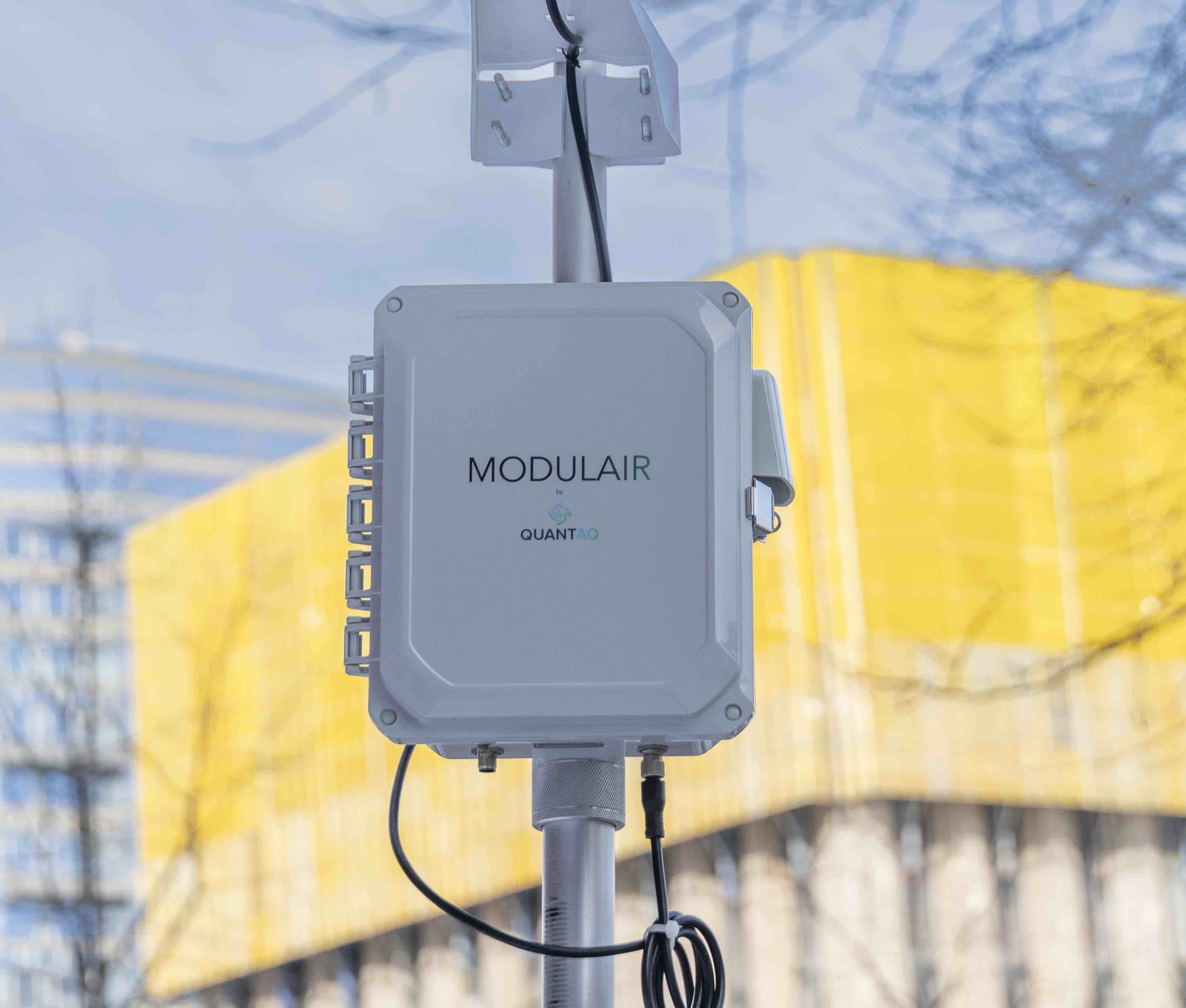MODULAIR device mounted on a pole in front of a building